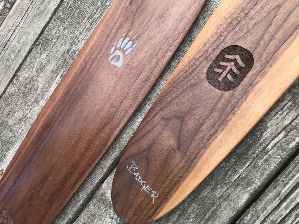 Special Edition Badger Walnut Canoe Paddles with aluminum inlay, laser engraved TreeEra logo, on barnyard background