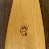 Detail view of a Cherry Sliver canoe paddle with a wood burned Badger paw logo