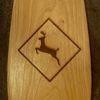 Detail view of a Cherry Sliver canoe paddle with a deer crossing motif laser engraved on blade.