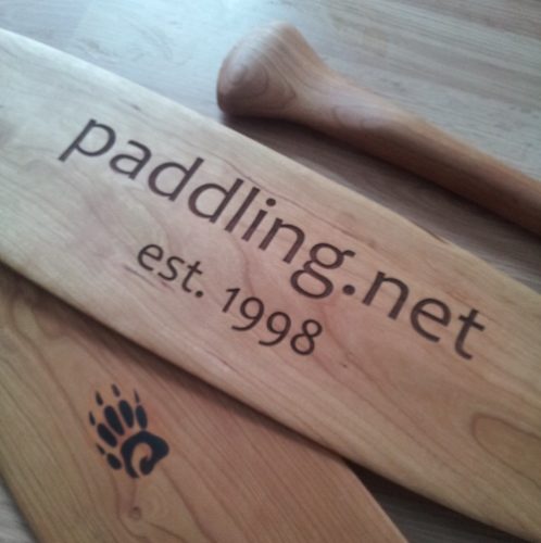 Detailed view of a Badger canoe paddle with an example of a LARGE custom laser engraved image (saying "paddling.net 1998")