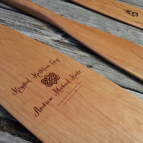 Detailed view of a Badger canoe paddle with an example of a MEDIUM custom laser engraved image taken from the customer's wedding invitations