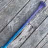 Detail of a purple tinted canoe paddle grip with a blended purple and blue shaft - on a barn board background.