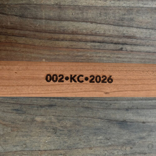 Partial zoomed-in close up of the shaft of a numbered paddle from The Happy Camper canoe paddle series,