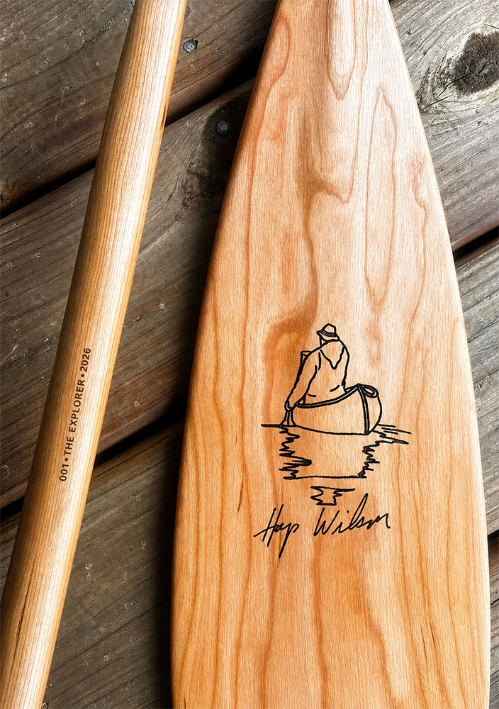 Example of cherry Explorer canoe paddle with Serialized canoe paddle engraving 001 The Explorer 2026 along with Laser engraved Hap Wilson artwork on canoe paddle
